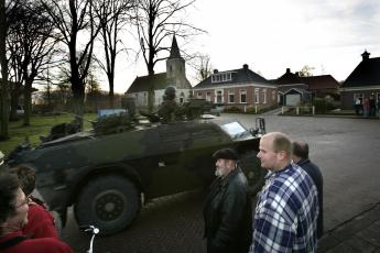 Een legervoertuig rijdt Vierhuizen binnen.