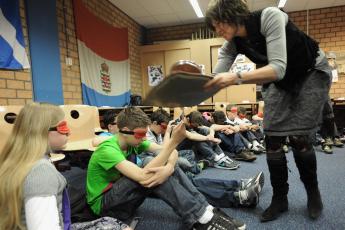 Door harde slagen op een dienblad schrikken de leerlingen.