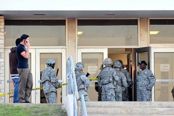 Militarien gaan het Soldier Readiness Center op een militaire basis in Texas binnen. Op deze plek werden de twaalf soldaten gedood.